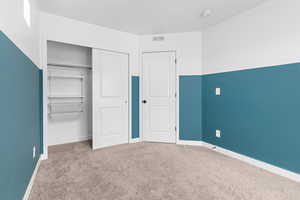 Unfurnished bedroom with carpet floors and a closet