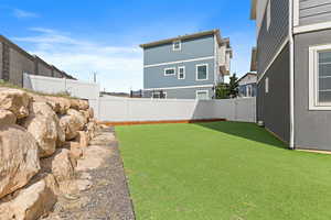 Fenced backyard featuring a gate