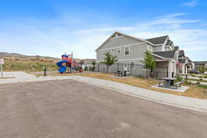 View of side of property featuring a shingled roof and a mountain view