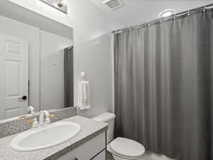 Full bathroom with vanity and toilet