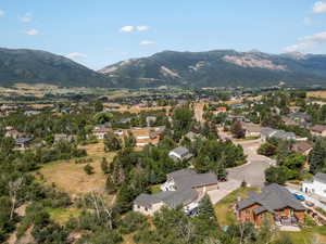 Aerial overview of property's location with a mountain backdrop and nearby suburban area