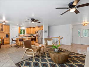 Living area featuring light tile patterned flooring, a ceiling fan, plenty of natural light, and recessed lighting