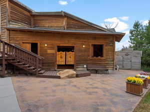 Back of property featuring a patio area and stairs