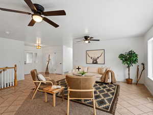 Dining space with light tile patterned floors and ceiling fan