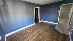 Empty room with wood finished floors and baseboards