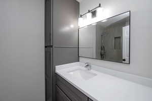 Full bath with vanity and a shower