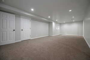 Finished below grade area featuring carpet flooring and recessed lighting