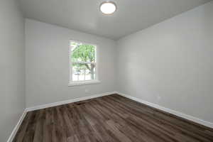 Empty room featuring dark wood-style floors