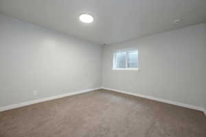 Unfurnished room featuring carpet floors and a smoke detector