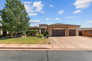 Mediterranean / spanish-style house featuring an attached garage, concrete driveway, stone siding, and stucco siding