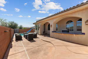 Fenced backyard with a patio and an outdoor living space