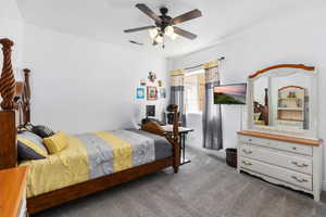 Carpeted bedroom featuring ceiling fan and baseboards