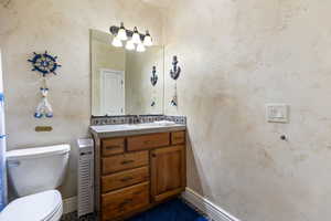 Half bath with vanity and toilet