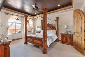 Bedroom featuring a raised ceiling, carpet floors, a ceiling fan, recessed lighting, and crown molding