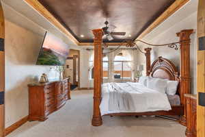 Bedroom featuring a tray ceiling, light carpet, ornamental molding, ceiling fan, and recessed lighting