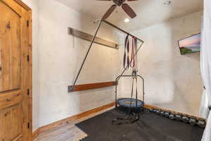 Exercise area featuring wood finished floors, ceiling fan, and recessed lighting