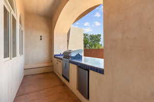 View of patio featuring an outdoor kitchen