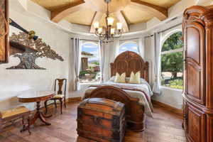Bedroom with a chandelier, hardwood / wood-style floors, and coffered ceiling