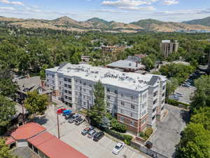 Drone / aerial view of a mountain backdrop and apartment complex