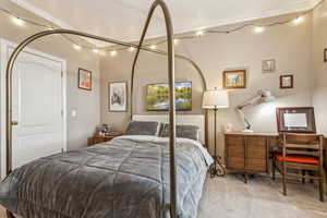 Carpeted bedroom with crown molding