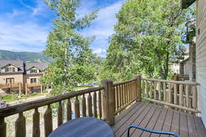 Wooden terrace featuring a mountain view and a residential view