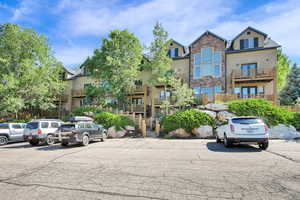 View of property featuring uncovered parking