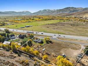 Aerial view of sparsely populated area with property boundaries highlighted and a mountain backdrop