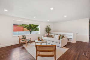 Living room featuring wood finished floors and recessed lighting