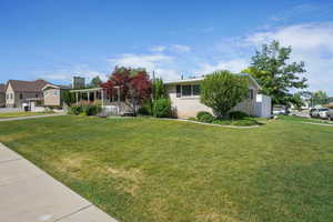 View of front of property with a front lawn and brick siding