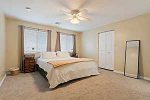 Bedroom featuring carpet flooring, ceiling fan, and a closet