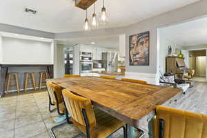 Dining space featuring light tile patterned flooring