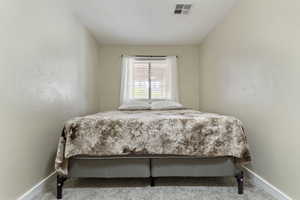 Carpeted bedroom with baseboards