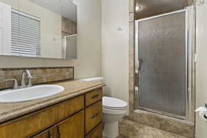 Bathroom with a stall shower and vanity