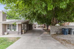 View of property exterior featuring stucco siding and a chimney