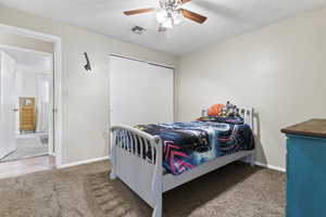 Bedroom featuring carpet floors, a ceiling fan, and a closet