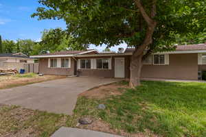 Single story home featuring stucco siding and driveway