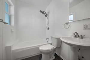 Bathroom featuring toilet and shower / bath combination