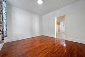 Unfurnished room featuring ornamental molding and hardwood / wood-style floors