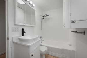 Full bath with tile patterned flooring, vanity, and shower / tub combination