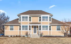 View of front of property featuring a shingled roof