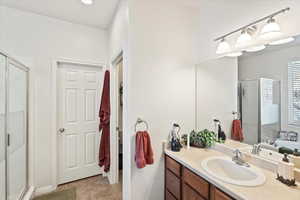 Full bath featuring a shower stall, vanity, tile patterned flooring, and a tub to relax in