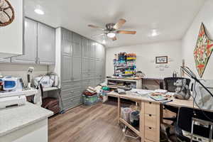 Office area with a ceiling fan, light wood-style floors, and recessed lighting