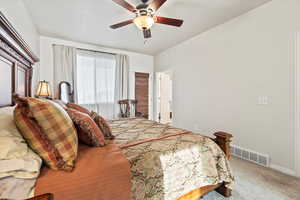 Carpeted bedroom featuring baseboards and ceiling fan