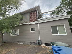 View of side of home featuring a balcony