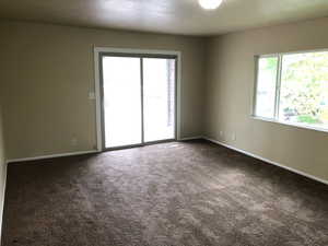 Spare room featuring baseboards and carpet flooring
