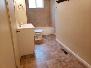 Bathroom with vanity and shower / washtub combination