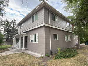 Back of property with a yard