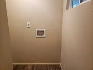 Laundry room featuring washer hookup and dark wood-style floors