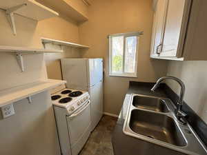 Kitchen featuring electric range and open shelves