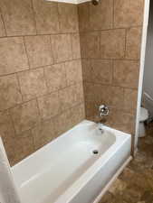 Bathroom with toilet and shower / bathtub combination